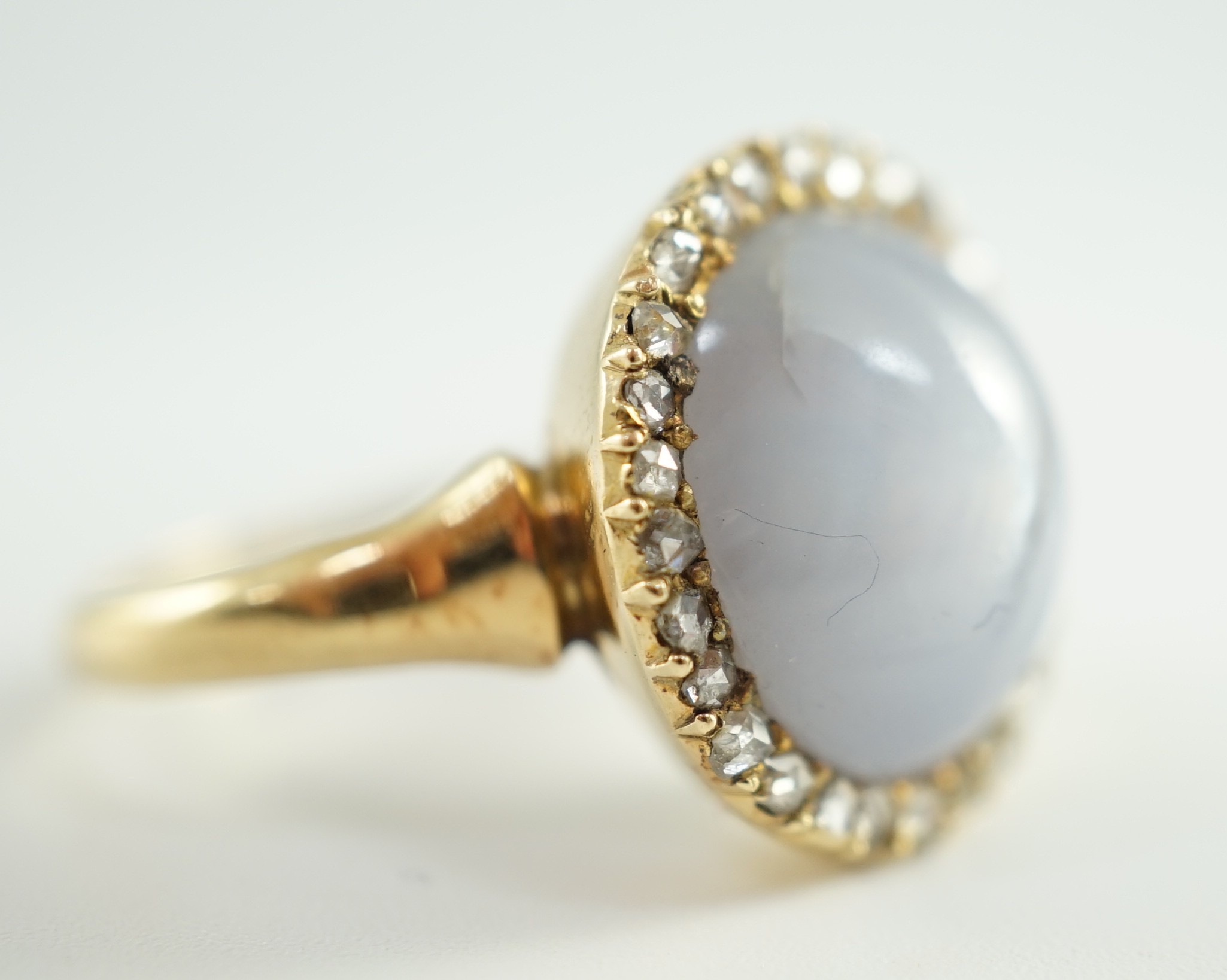 An early to mid 20th century 18ct gold, cabochon star sapphire and rose cut diamond set oval cluster ring